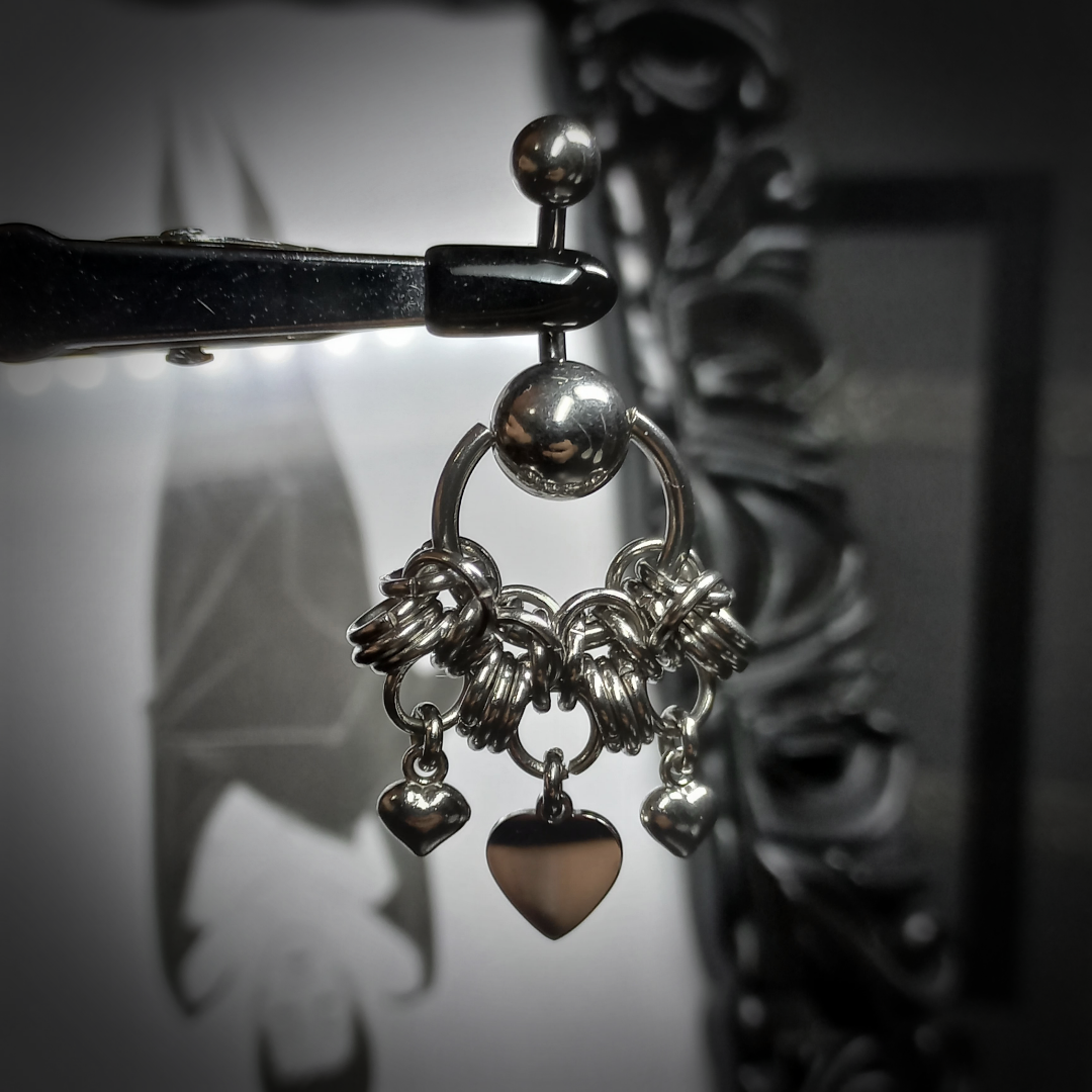 Heart-shaped belly button piercing